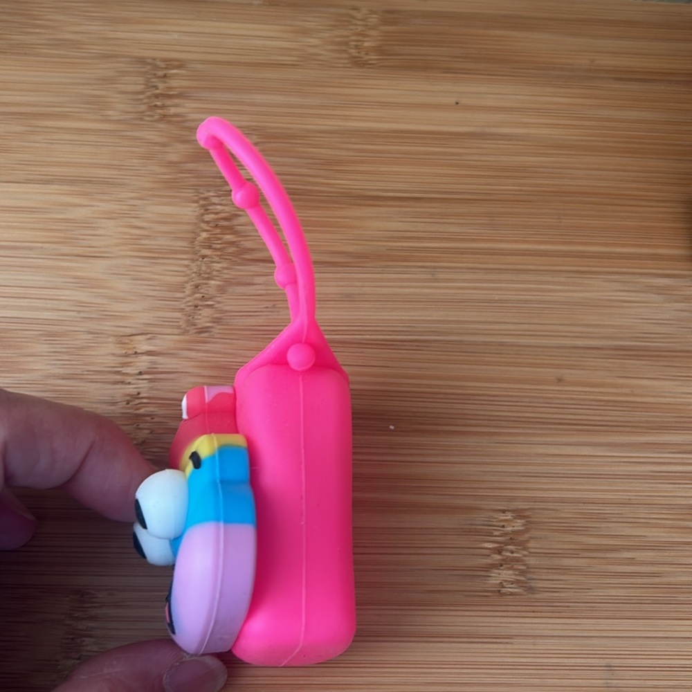 Colorful Smiling Poop Emoji hand sanitizer holder - Picture 2 of 4